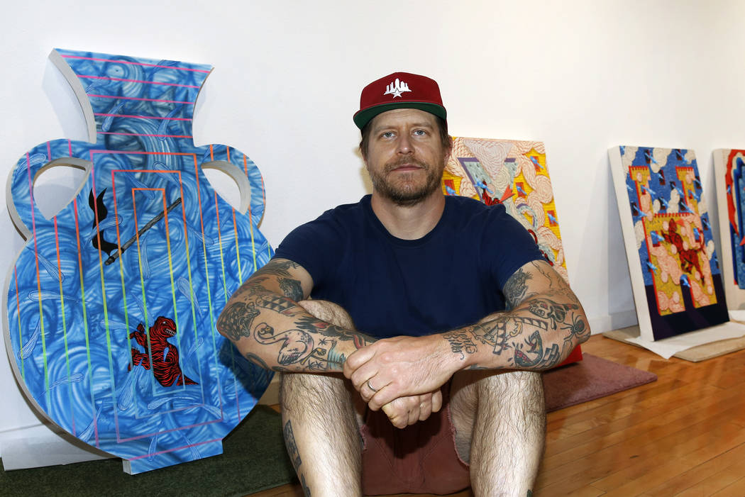 Los Angeles-based artist, Andrew Schoultz, poses for photo with his artwork at the UNLV Marjorie Barrick Museum of Art on Friday, May 25, 2018, in Las Vegas. Schoultz's art exhibit will be held fr ...