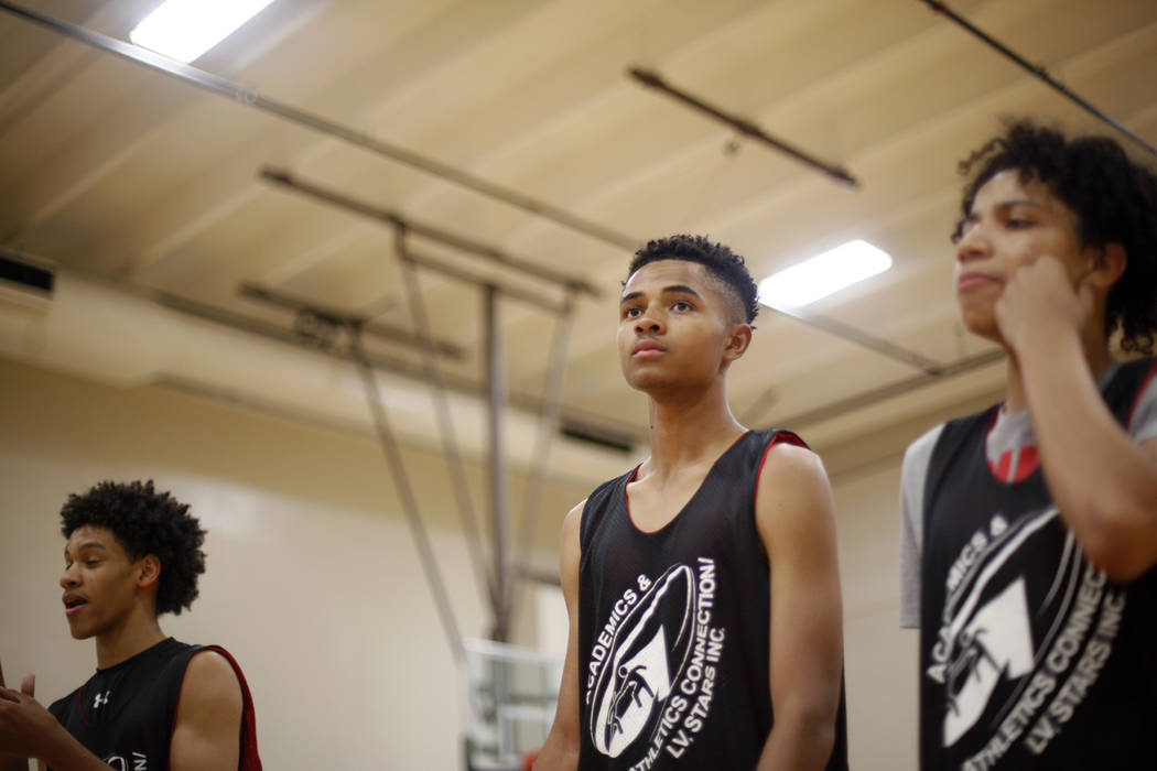 Jordan Carter, 18, from left, D'Andre Burnett, and Jordan McGriff listen to instruction during basketball practice for the LV Stars at the Chuck Minker Sports Complex in Las Vegas, Tuesday, May 8, ...