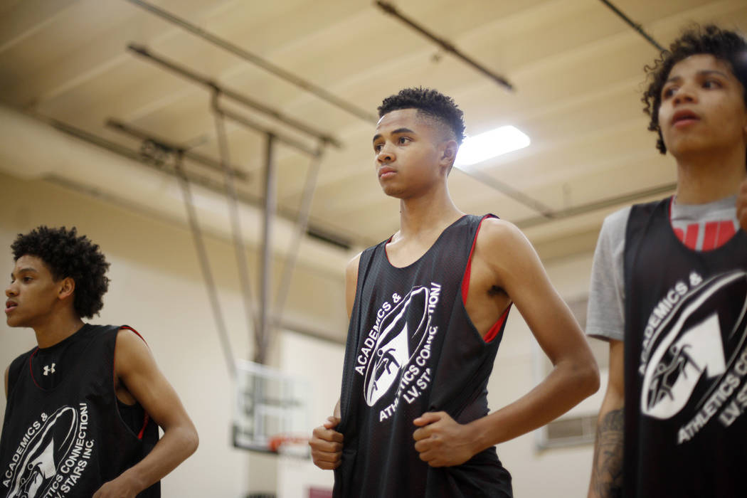 Jordan Carter, 18, from left, D'Andre Burnett, and Jordan McGriff listen to instruction during basketball practice for the LV Stars at the Chuck Minker Sports Complex in Las Vegas, Tuesday, May 8, ...