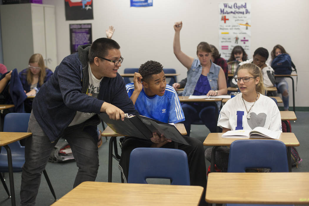 Carlos Hernandez-Munoz points out the answer to D'Andre Burnett and Marykate Springer as a student group leads a presentation in math class at Shadow Ridge High School in Las Vegas, Wednesday, May ...