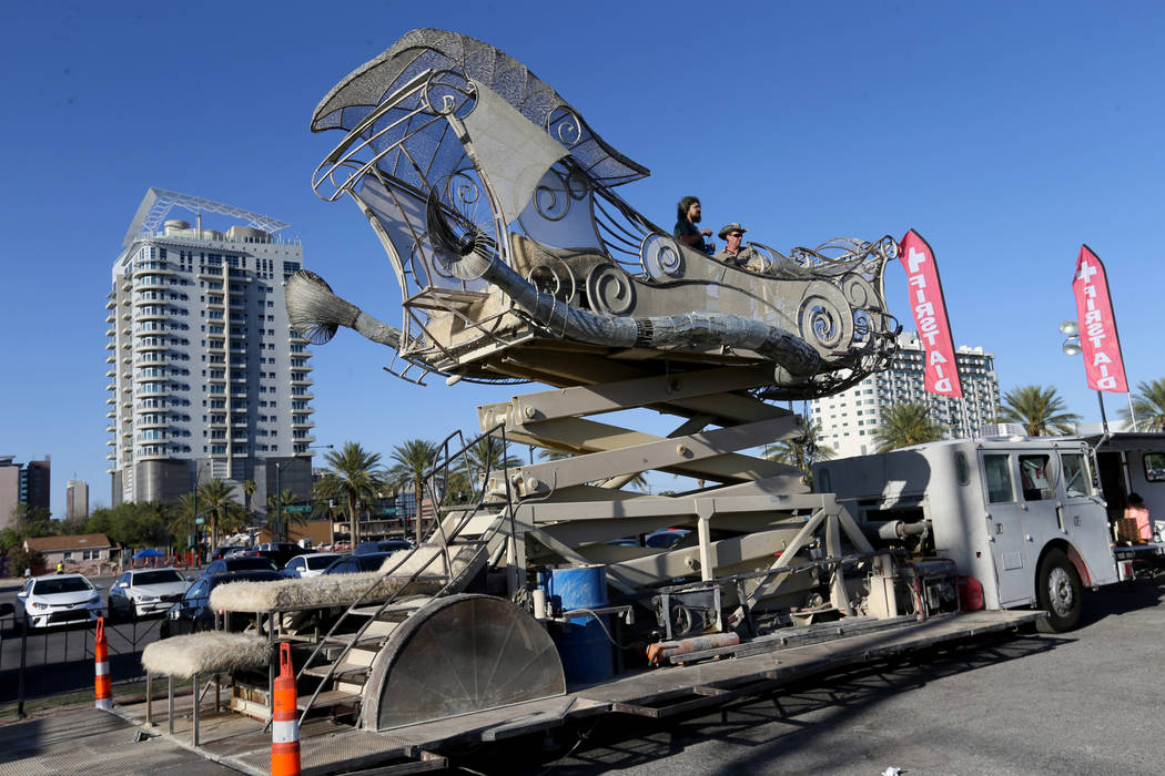 Charlie Blankenship, left, and Tomas Toulee raise BalanceVille art car into the air at First Friday in the Arts District of downtown Las Vegas June 1, 2018. The art car was on display to promote t ...
