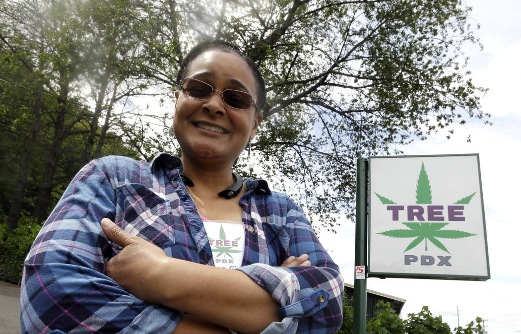 Tree PDX marijuana shop owner Brooke Smith poses for a photo outside her small shop in Portland, Ore., last month. (AP Photo/Don Ryan)