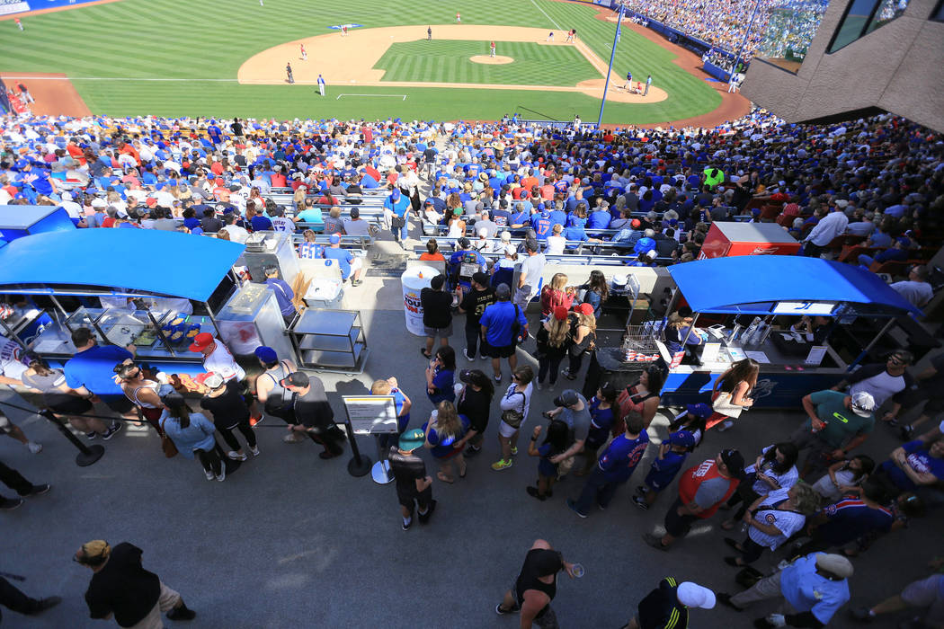 A concession stand line stretches into the covered concourse area during a game between the Chicago Cubs and the Cincinnati Reds at Cashman Field in Las Vegas on Sunday, March 26, 2017. (Brett Le ...