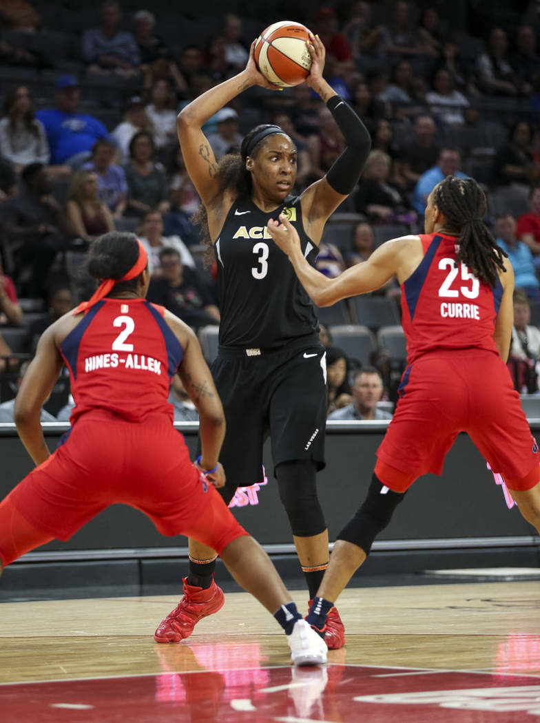 Las Vegas Aces center Kelsey Bone (3) looks to pass against Washington Mystics forwards Myisha Hines-Allen (2) and Monique Currie (25) in the second half of a WNBA basketball game at the Mandalay ...