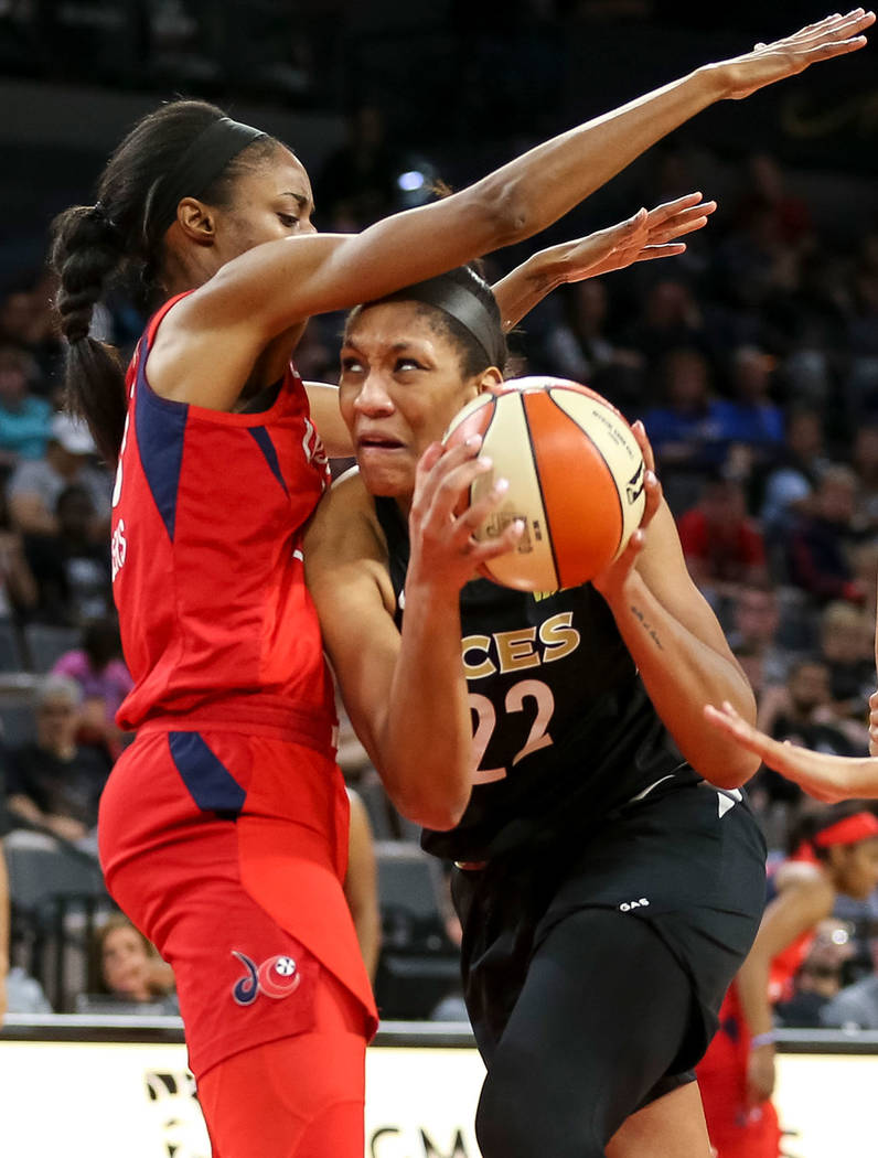 Las Vegas Aces center A'ja Wilson (22) goes to the basket against Washington Mystics forward LaToya Sanders (30) in the second half of a WNBA basketball game at the Mandalay Bay Events Center in L ...