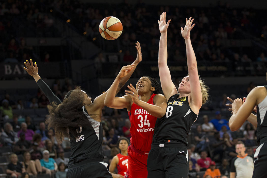Washington Mystics center Krystal Thomas (34) gets blocked by Las Vegas Aces centers Kelsey Bone (3) and Carolyn Swords (8) in the first half of a WNBA basketball game at the Mandalay Bay Events C ...