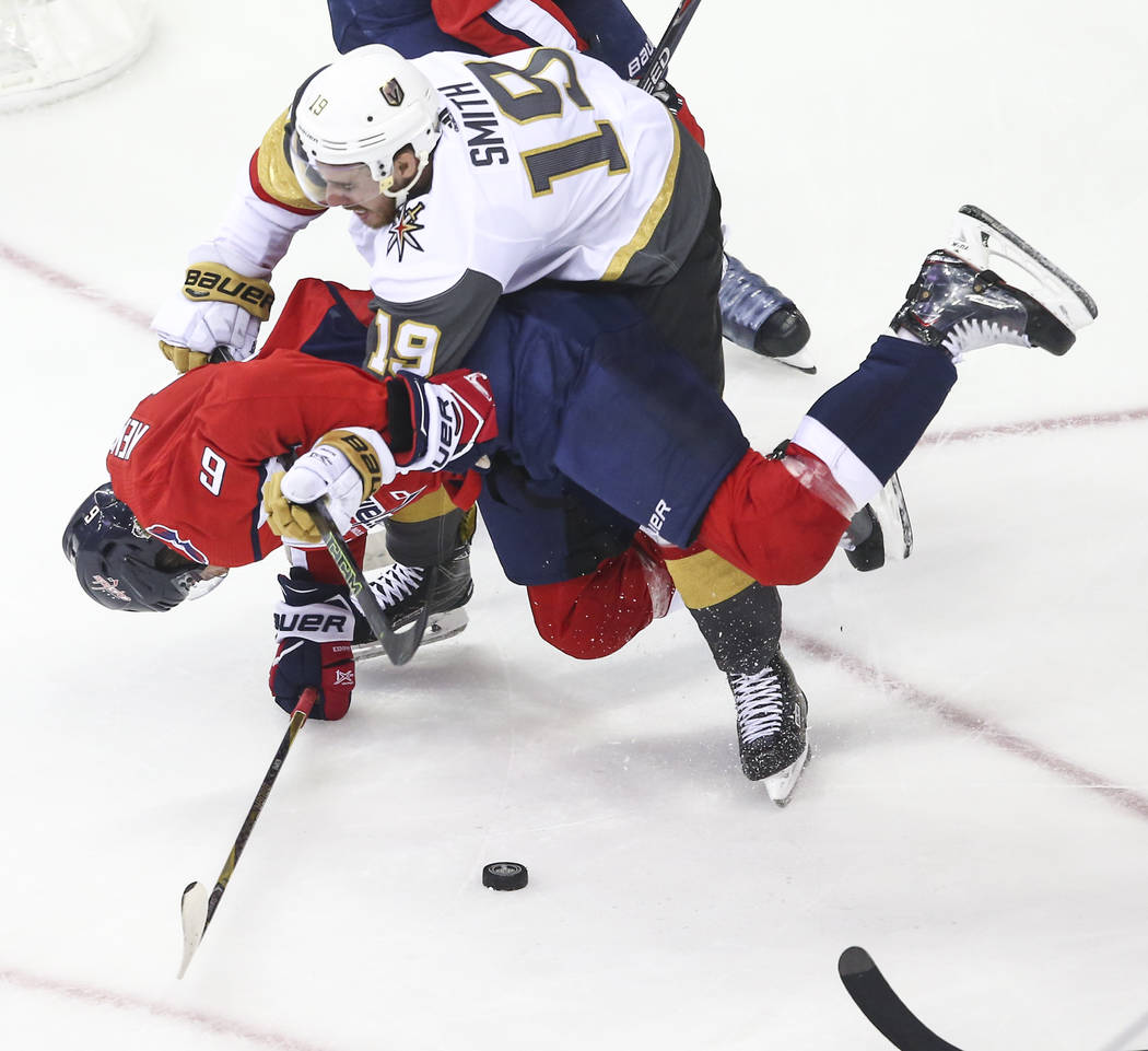 Golden Knights right wing Reilly Smith (19) knocks down Washington Capitals defenseman Michal Kempny (6) during the first period of Game 3 of the NHL hockey Stanley Cup Final at Capital One Arena ...