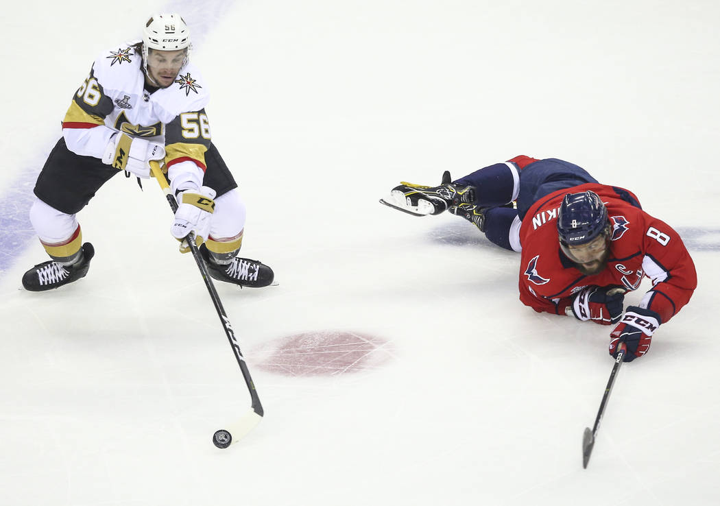Golden Knights left wing Erik Haula (56) controls the puck as Washington Capitals left wing Alex Ovechkin (8) slips on the ice during the first period of Game 3 of the NHL hockey Stanley Cup Final ...