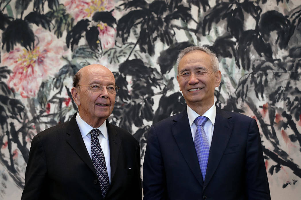U.S. Commerce Secretary Wilbur Ross, left, chats with Chinese Vice Premier Liu He during a photograph session after their meeting at the Diaoyutai State Guesthouse in Beijing, Sunday, June 3, 2018 ...