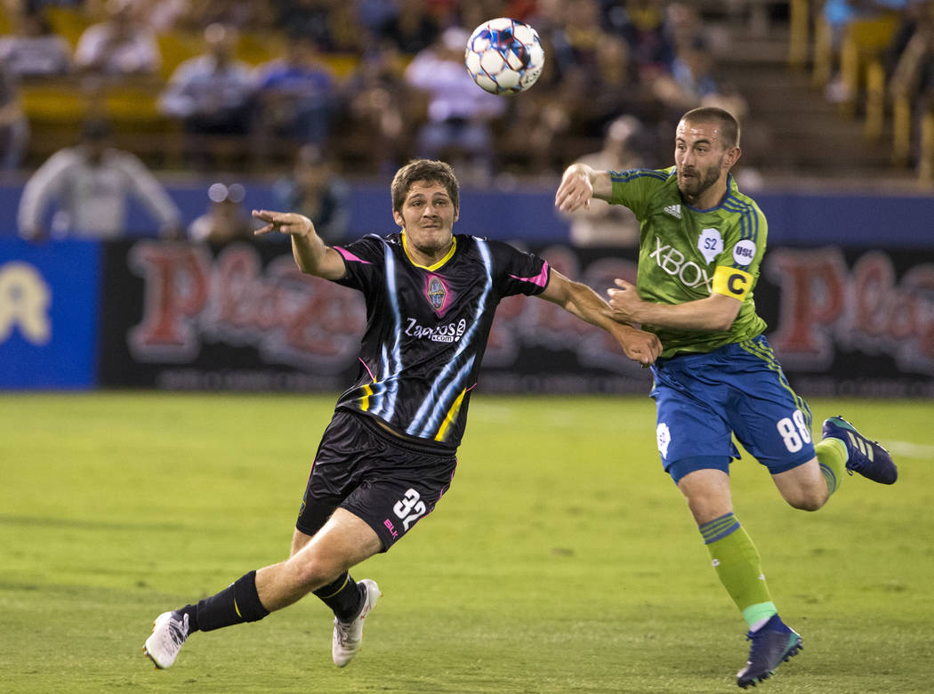 Las Vegas Lights FC midfielder Zach Mather (32) and Seattle Sounders FC 2 midfielder Ray Saari (88) vie for the ball during the first half of a United Soccer League match at Cashman Field in downt ...