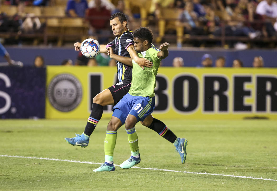 Las Vegas Lights FC forward Sammy Ochoa (9) and Seattle Sounders FC 2 defender Nick Hinds (31) vie for the ball during the second half of a United Soccer League match at Cashman Field in downtown ...