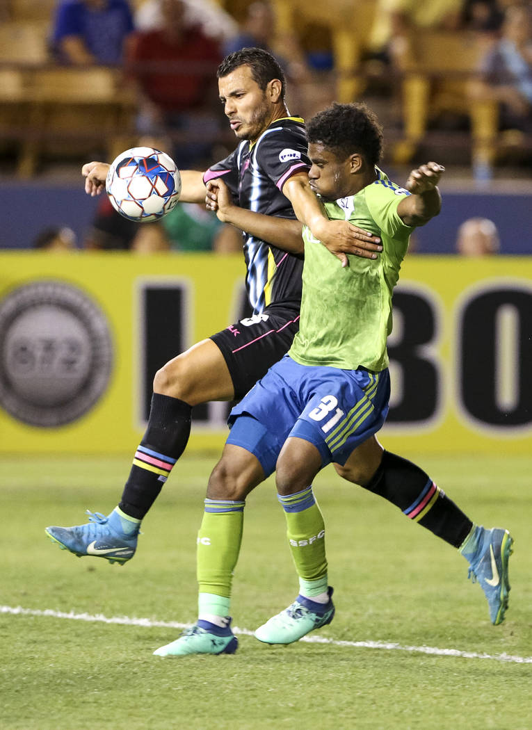 Las Vegas Lights FC forward Sammy Ochoa (9) and Seattle Sounders FC 2 defender Nick Hinds (31) vie for the ball during the second half of a United Soccer League match at Cashman Field in downtown ...