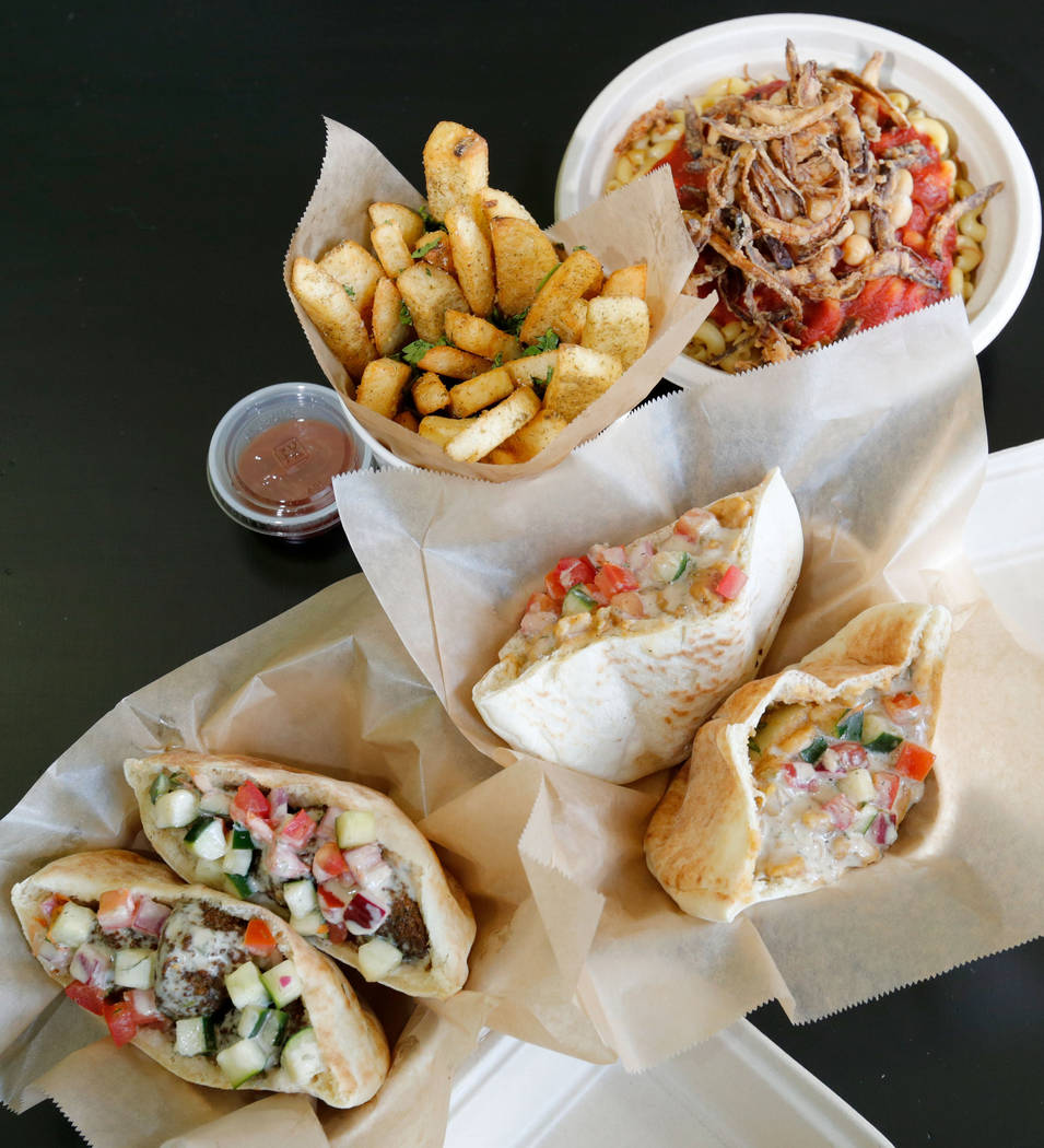 Taamia, bottom left, Ful Mudammas, bottom right, Egyptian Fries, top left, and Koshari, top right, are served at Pots in Las Vegas, Thursday, June 7, 2018. Pots is a vegan and vegetarian restauran ...