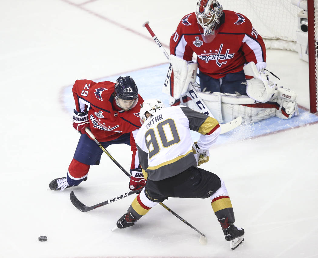 Golden Knights left wing Tomas Tatar (90) and Washington Capitals defenseman Christian Djoos (29) battle for the puck during the first period of Game 4 of the Stanley Cup Final at Capital One Aren ...