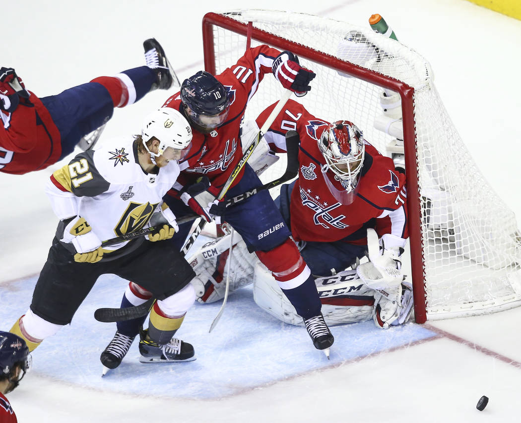 Golden Knights center Cody Eakin (21) battles against Washington Capitals right wing Brett Connolly (10) in front of goaltender Braden Holtby (70) during the first period of Game 4 of the Stanley ...