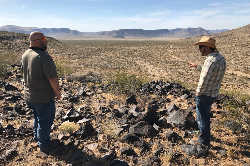 Patrick Donnelly from the Center for Biological Diversity, right, and Jim Stanger, president of the Friends of Sloan Canyon, look out Tuesday over Hidden Valley, south of Henderson, wher ...