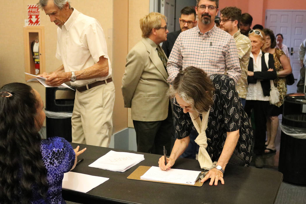 Hermi Hiatt of Las Vegas signs in to a public meeting at the Clark County Library in Las Vegas, Tuesday, June 5, 2018. A crowd filled the Clark County Library conference room Tuesday afternoon whe ...