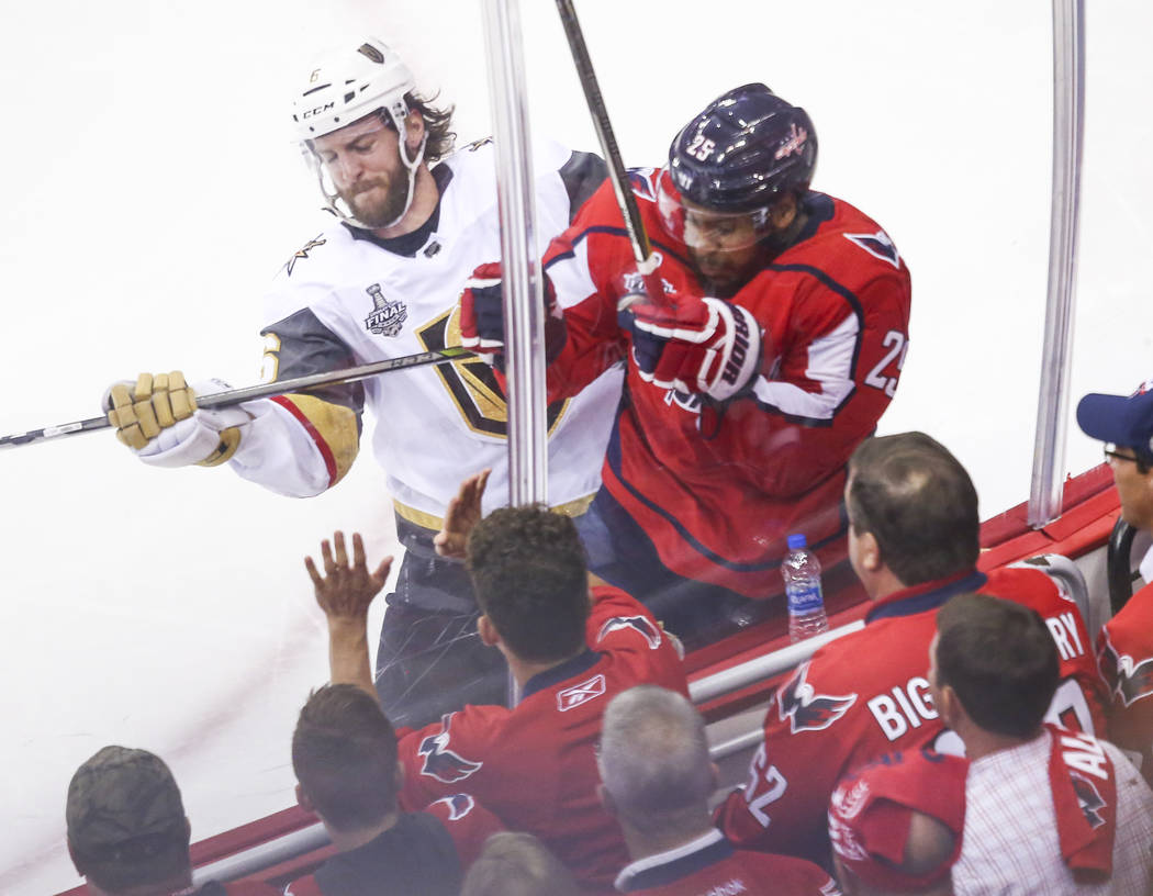 Golden Knights defenseman Colin Miller (6) checks Washington Capitals right wing Devante Smith-Pelly (25) during the second period of Game 4 of the Stanley Cup Final at Capital One Arena in Washin ...