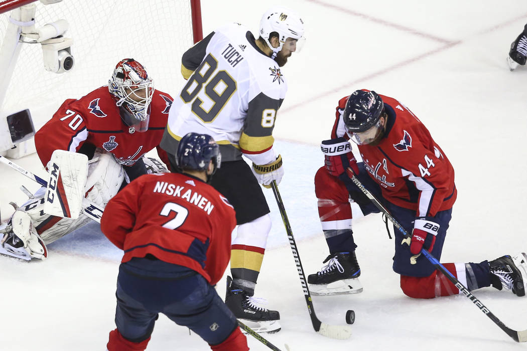 Golden Knights right wing Alex Tuch (89) and Washington Capitals defenseman Brooks Orpik (44) battle for the puck in front of goaltender Braden Holtby (70) during the second period of Game 4 of th ...