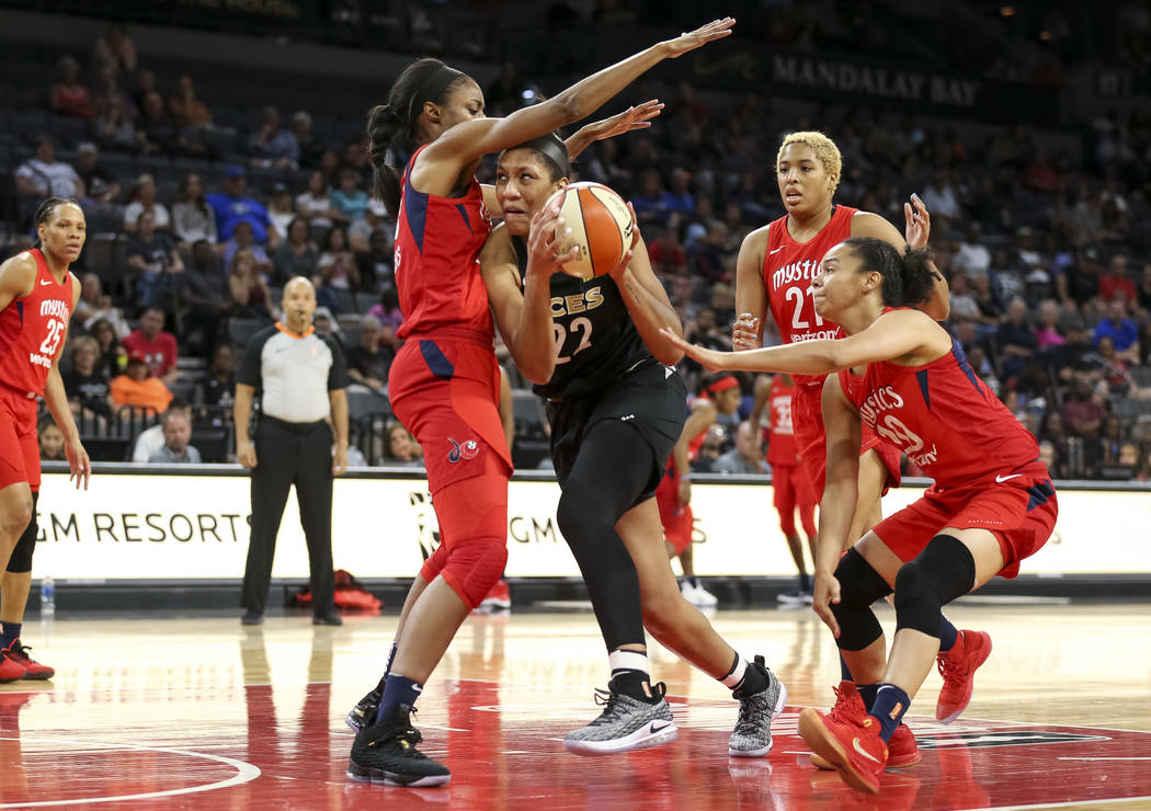 Las Vegas Aces center A'ja Wilson (22) goes to the basket against Washington Mystics forward LaToya Sanders (30) in the second half of a WNBA basketball game at the Mandalay Bay Events Center in L ...
