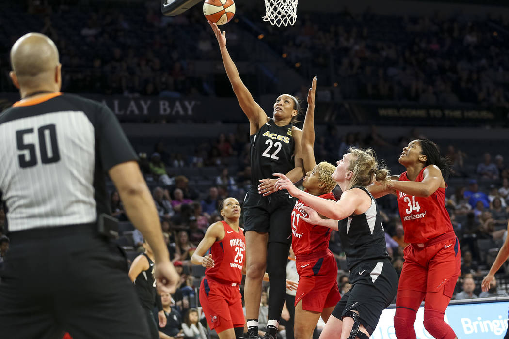 Las Vegas Aces center A'ja Wilson (22) takes a shot over Washington Mystics forward Tianna Hawkins (21) in the second half of a WNBA basketball game at the Mandalay Bay Events Center in Las Vegas ...