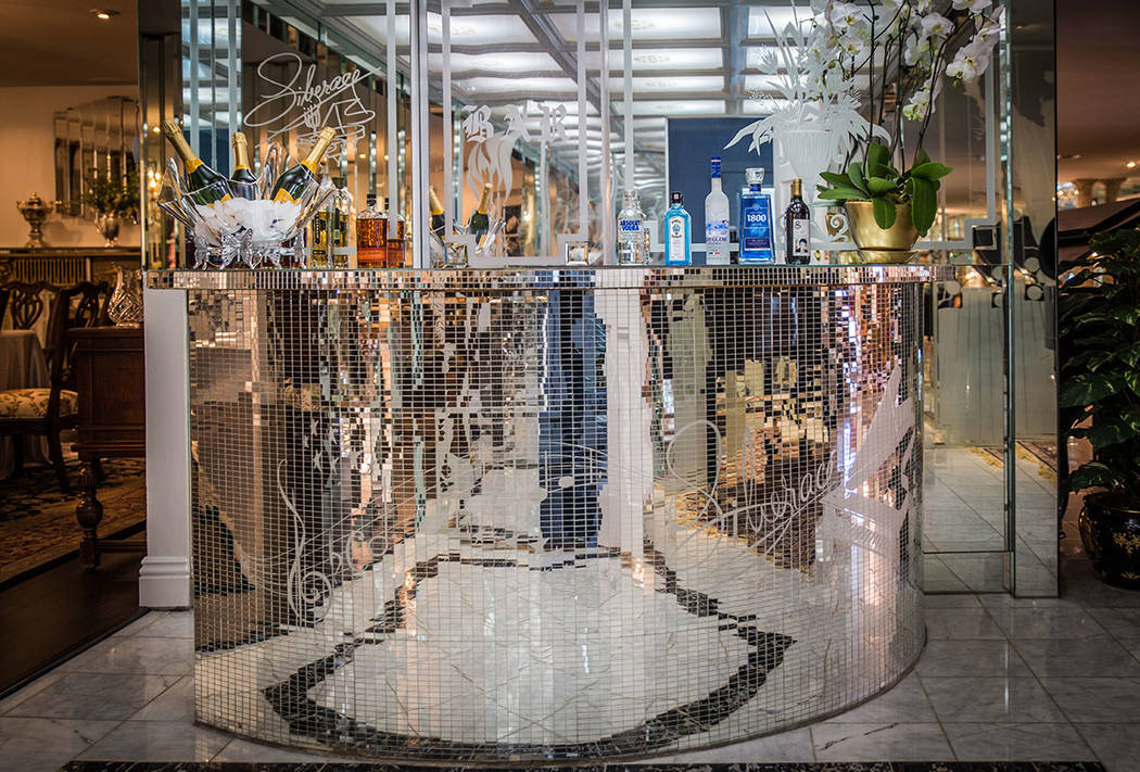 A decorative mirrored bar with etchings of Liberace’s name and music notes are near a formal dining room. (Tonya Harvey Real Estate Millions)