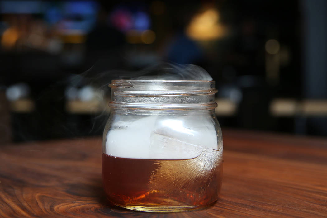The Holy Smokes! cocktail, served with bourbon, maple, chocolate, and hickory smoke, at Eureka restaurant, 520 E. Fremont St., in Las Vegas, Wednesday, June 13, 2018. Erik Verduzco Las Vegas Revie ...