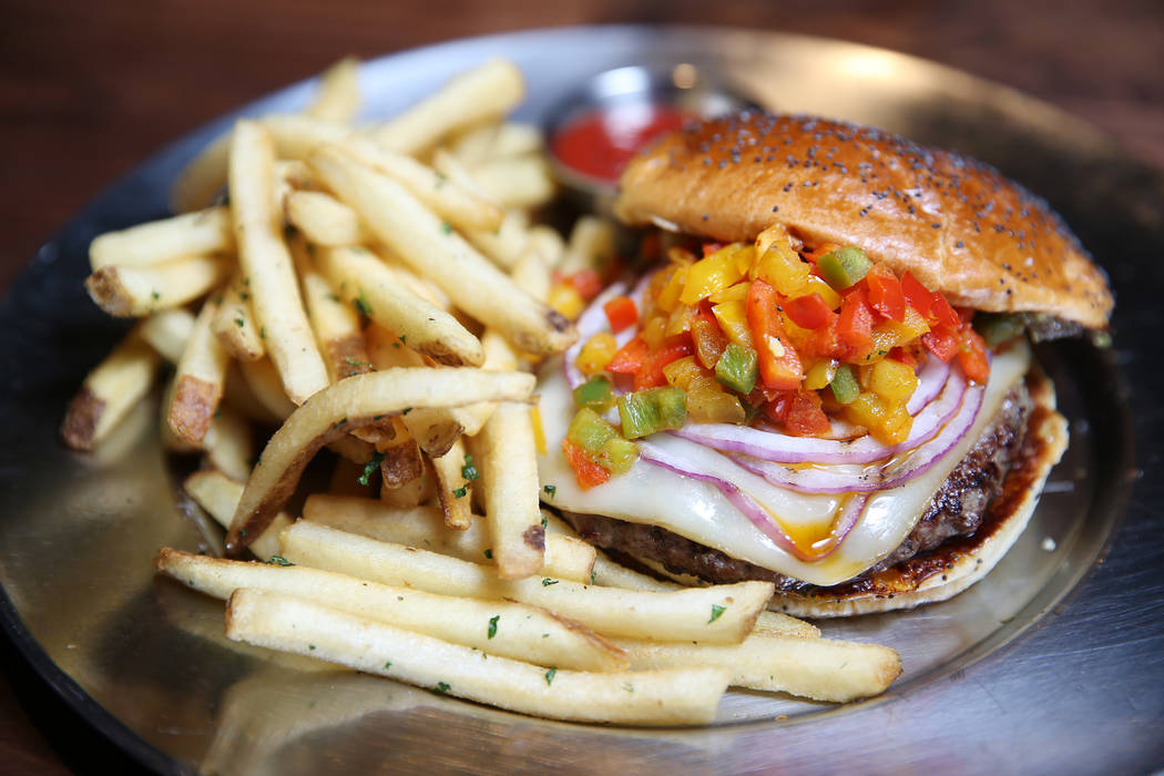 The Bison Burger, served with bacon-infused jalapeño jam, charbroiled tricolor piers, grilled red onions, and smoked mozzarella, at Eureka restaurant, 520 E. Fremont St., in Las Vegas, Wednes ...