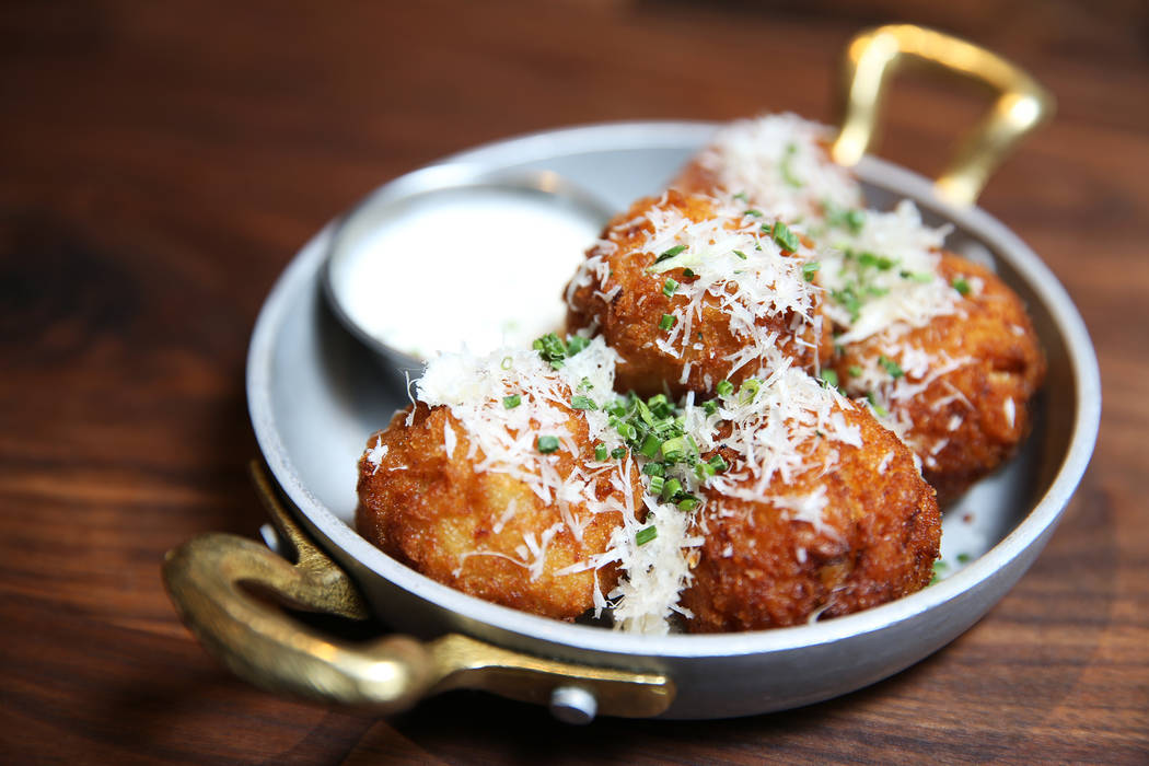 The Mc N' Cheese Balls, served with beer cheese sauce, Fresno chiles, chives and parmesan cheese, at Eureka restaurant, 520 E. Fremont St., in Las Vegas, Wednesday, June 13, 2018. Erik Verduzco La ...