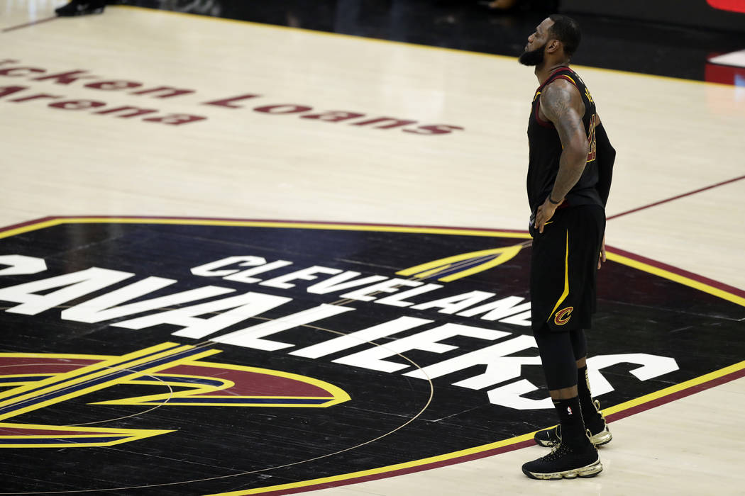 Cleveland Cavaliers' LeBron James watches during the first half of Game 4 of basketball's NBA Finals against the Golden State Warriors, Friday, June 8, 2018, in Cleveland. (AP Photo/Tony Dejak)
