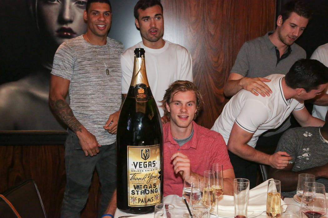 Members of the Vegas Golden Knights, clockwise from upper left, Ryan Reaves, Will Carrier, Jonathan Maechessault (looking away), Shea Theodore and Jon Merrill (seated) are shown with a 15-liter bo ...