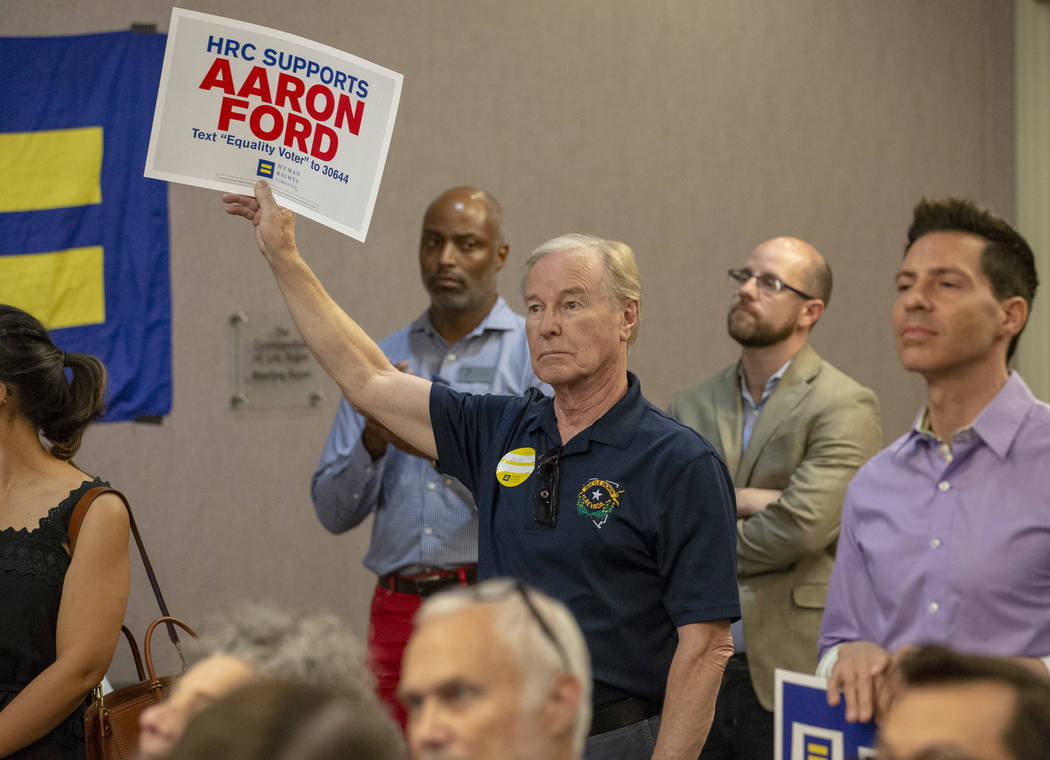 Senator David Parks, D-Las Vegas, holds a sign in support of fellow Senator and Attorney General candidate Aaron Ford during a Get Out the Vote rally hosted by the Human Rights Campaign at The Gay ...