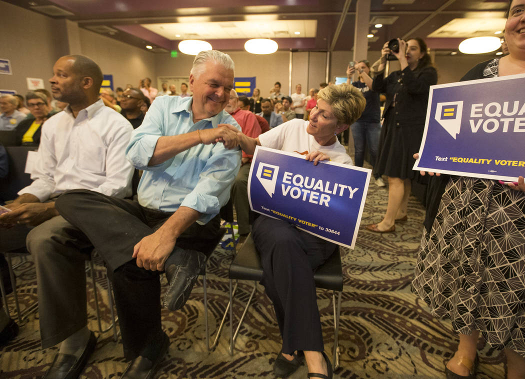 Democratic gubernatorial candidates Steve Sisolak, second left, and Chris Giunchigliani shake hands during a Get Out the Vote rally hosted by the Human Rights Campaign at The Gay and Lesbian Commu ...
