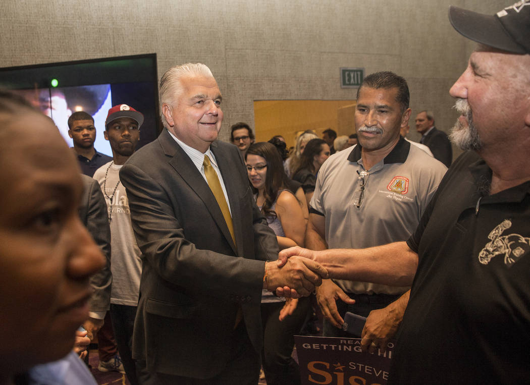 Steve Sisolak, middle, shakes hands with supporters at a watch party after winning the gubernatorial democratic primary at the Aria hotel-casino on Tuesday, June 12, 2018, in Las Vegas. Benjamin H ...