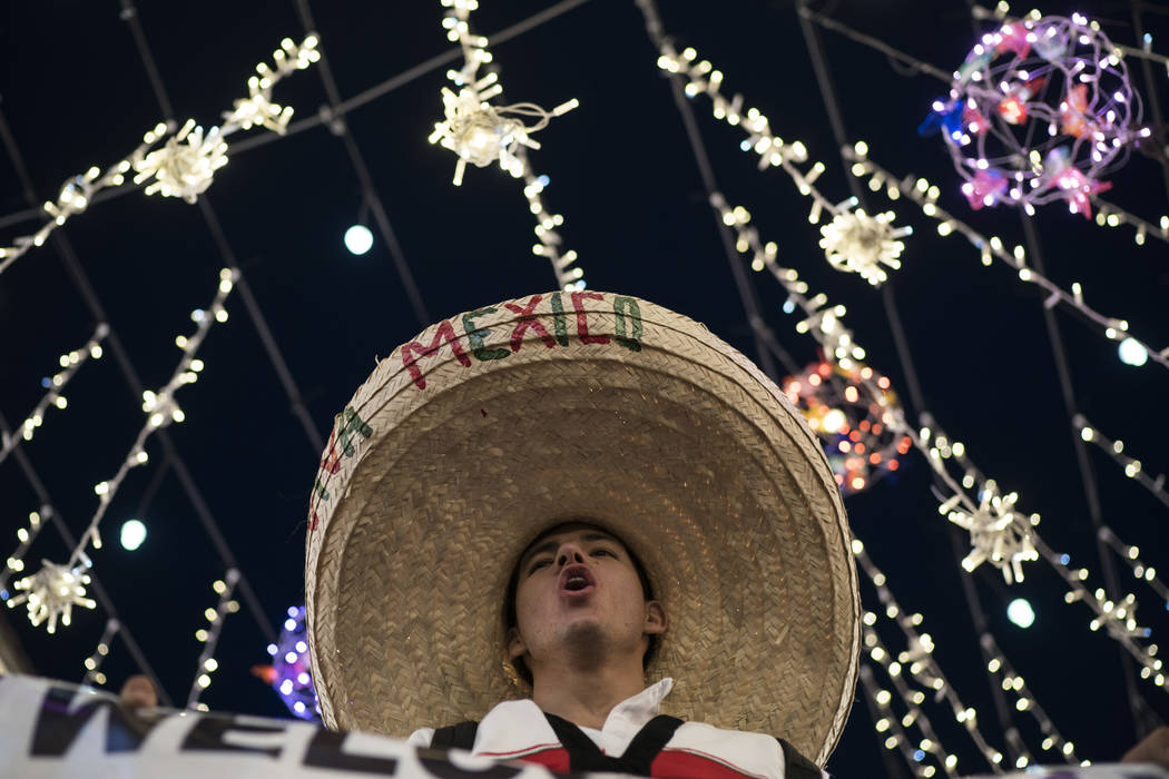 A Mexico soccer fan wearing a sombrero chants as fans gather on Nikolskaya Street ahead of the 2018 soccer World Cup in Moscow, Russia, Wednesday, June 13, 2018. Fans from participating countries ...