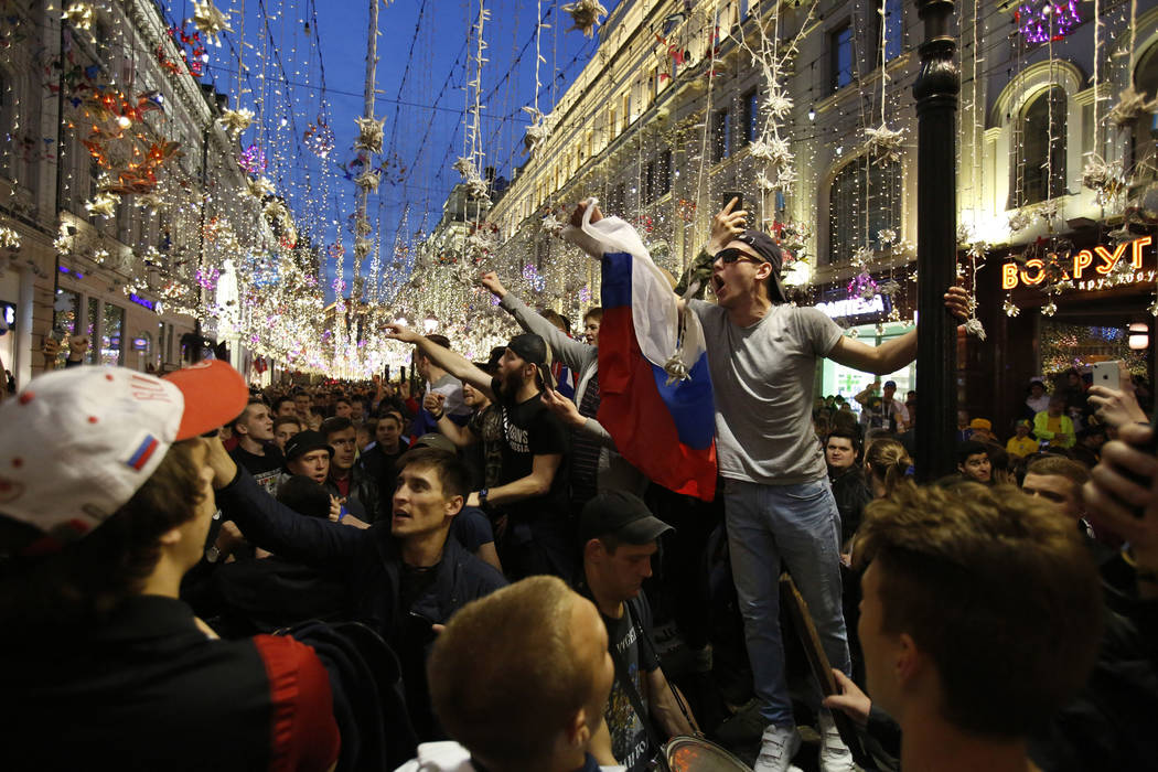 Russia fans celebrate in Nikolskaya street after their team defeated Saudi Arabia 5-0 in the opening match of the 2018 soccer World Cup, in Moscow, Russia, Thursday, June 14, 2018.(AP Photo/Rebecc ...