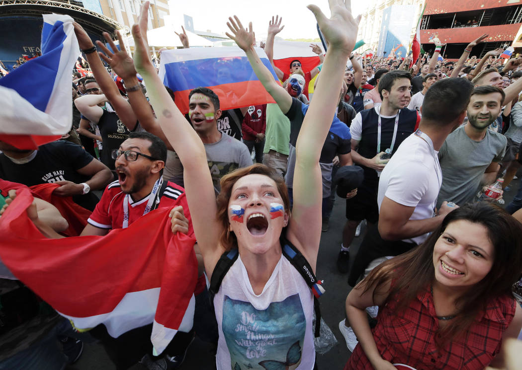 Fans celebrate a Russia's goal at a fan zone during the 2018 soccer World Cup match between Russia and Saudi Arabia in St.Petersburg, Russia, Thursday, June 14, 2018. (AP Photo/Dmitri Lovetsky)