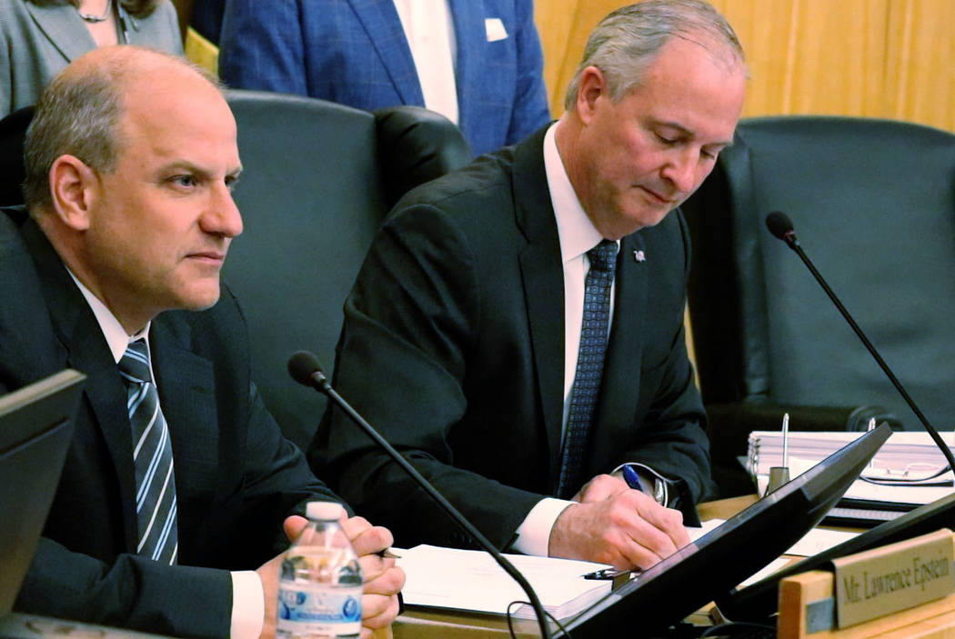 Steve Hill, seated right, signs the stadium development and lease agreements for the Las Vegas Stadium with Raiders President Marc Badain, seated left, in Las Vegas Wednesday, March 28, 2018. Made ...