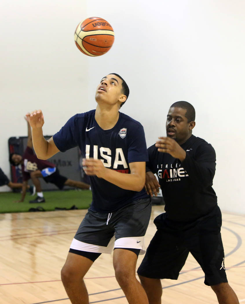 Keith Owens, right, director of player development at Athletic Gaines, defense Liberty High School junior Julian Strawther on Tuesday, June 12, 2018 during Strawther workout in preparation for a t ...
