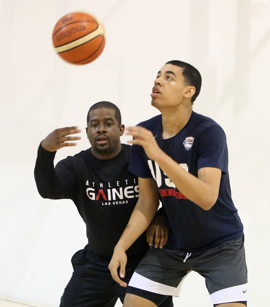 Keith Owens, left, director of player development at Athletic Gaines, defense Liberty High School junior Julian Strawther on Tuesday, June 12, 2018 during Strawther workout in preparation for a tr ...