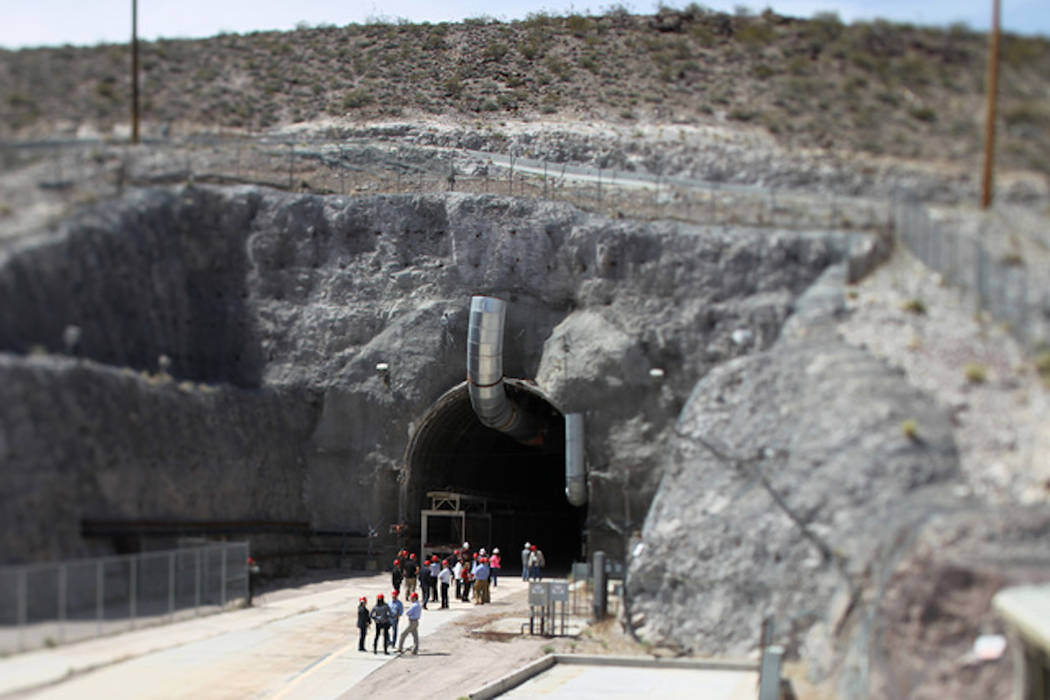 Congressional staff members, media and Department of Energy employees wait for congressmen to emerge from the north portal during a congressional tour of the Yucca Mountain exploratory tunnel Thur ...