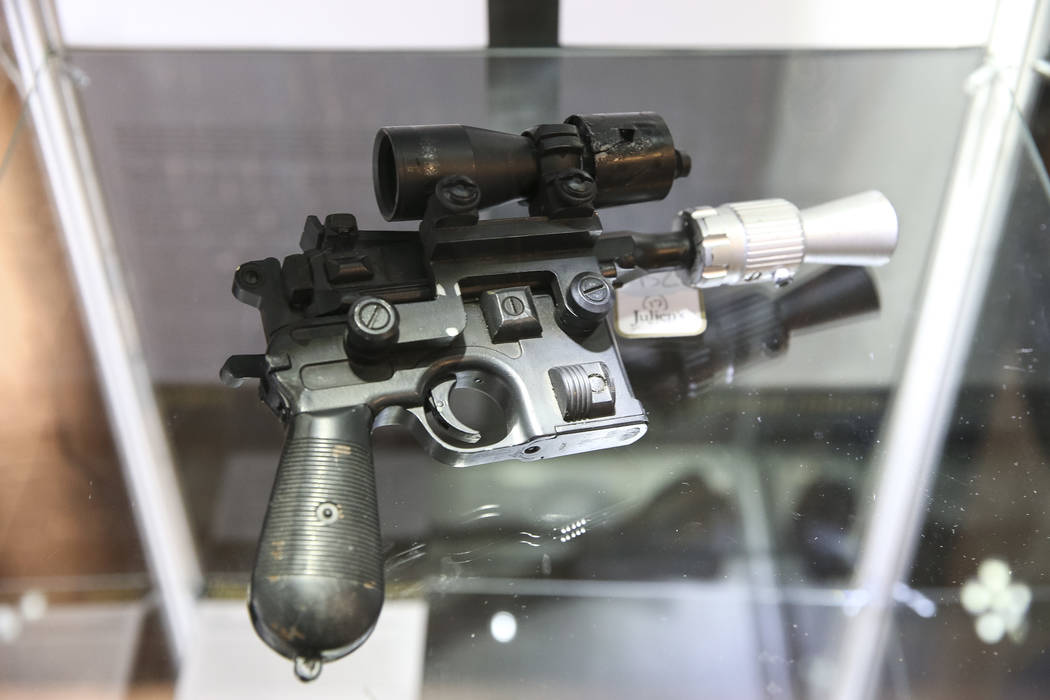 An original production of the "BlasTech DL-44" blaster prop used by Harrison Ford as Han Solo in Return of the Jedi on display as part of Julian's Auctions Hollywood Legends collection a ...