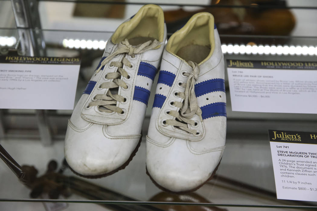 A pair of shoes once owned by actor Bruce Lee on display as part of Julian's Auctions Hollywood Legends collection at Planet Hollywood in Las Vegas on Monday, June 18, 2018. Items from the Hollywo ...