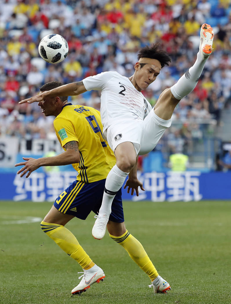 South Korea's Lee Yong is challenged by Sweden's Marcus Berg during the group F match between Sweden and South Korea at the 2018 soccer World Cup in the Nizhny Novgorod stadium in Nizhny ...