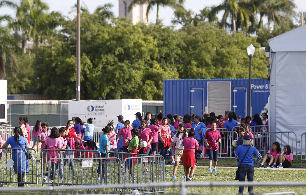 Immigrant children play outside a former Job Corps site that now houses them, Monday, June 18, 2018, in Homestead, Fla. It is not known if the children crossed the border as unaccompanied minors o ...