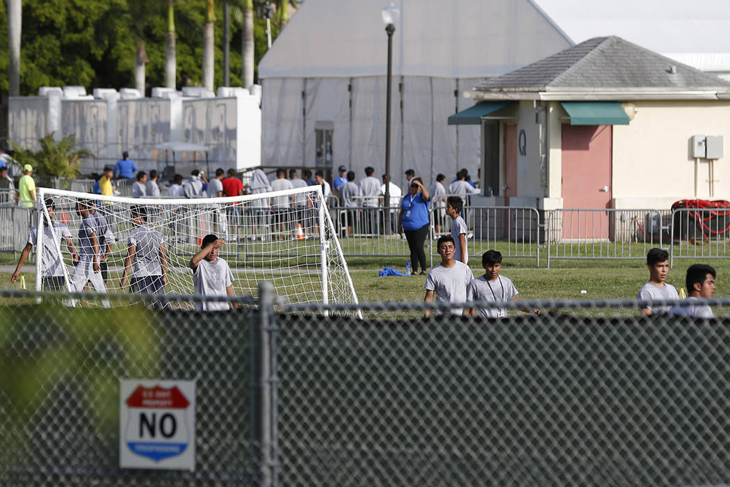 Immigrant children play outside a former Job Corps site that now houses them, Monday, June 18, 2018, in Homestead, Fla. It is not known if the children crossed the border as unaccompanied minors o ...