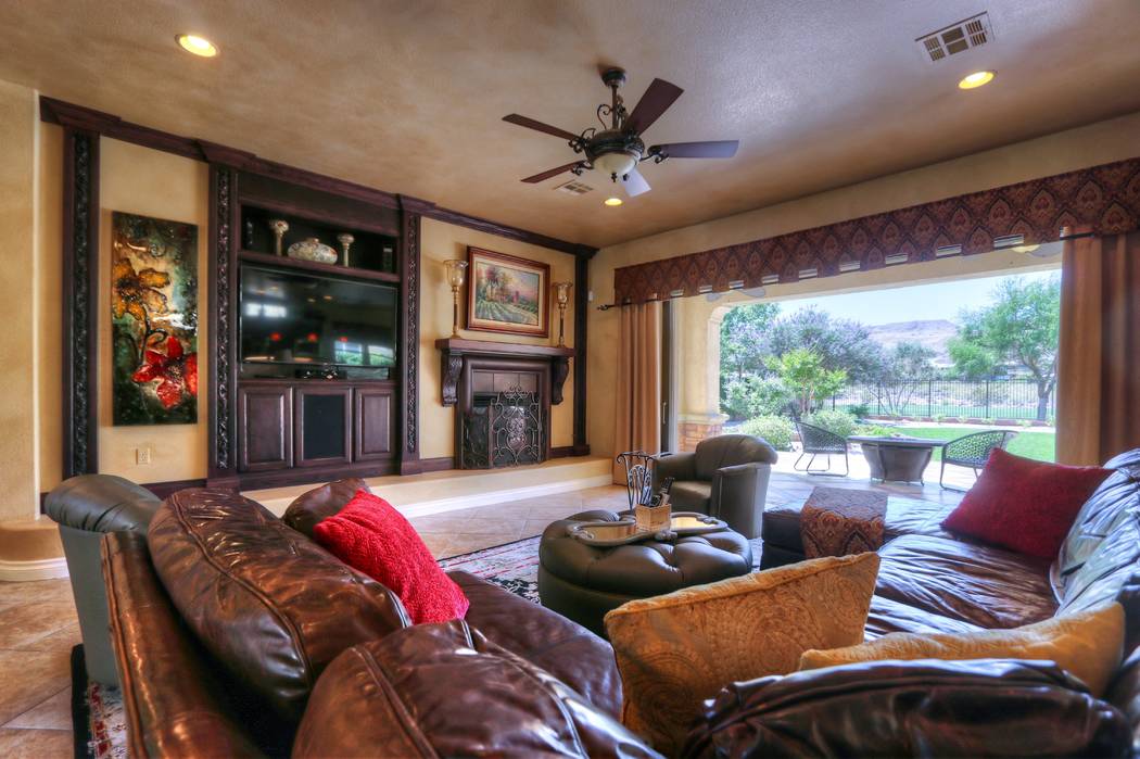 The living room opens to the patio that overlooks the golf course. (Lisa Paquette TourFactory)