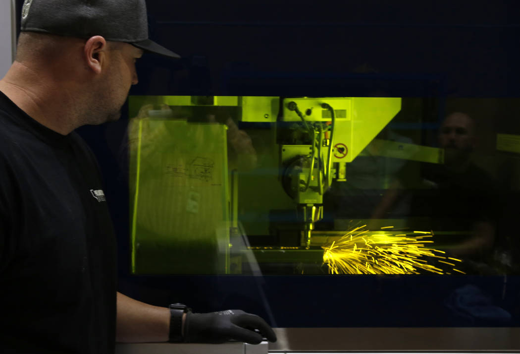 Jordan Yost, co-owner of Precision Tube Laser, LLC, watches as the TruLaser Tube 5000 laser cutting machine cuts out a piece of metal on Wednesday, June 20, 2018, in Las Vegas. Bizuayehu Tesfaye/L ...