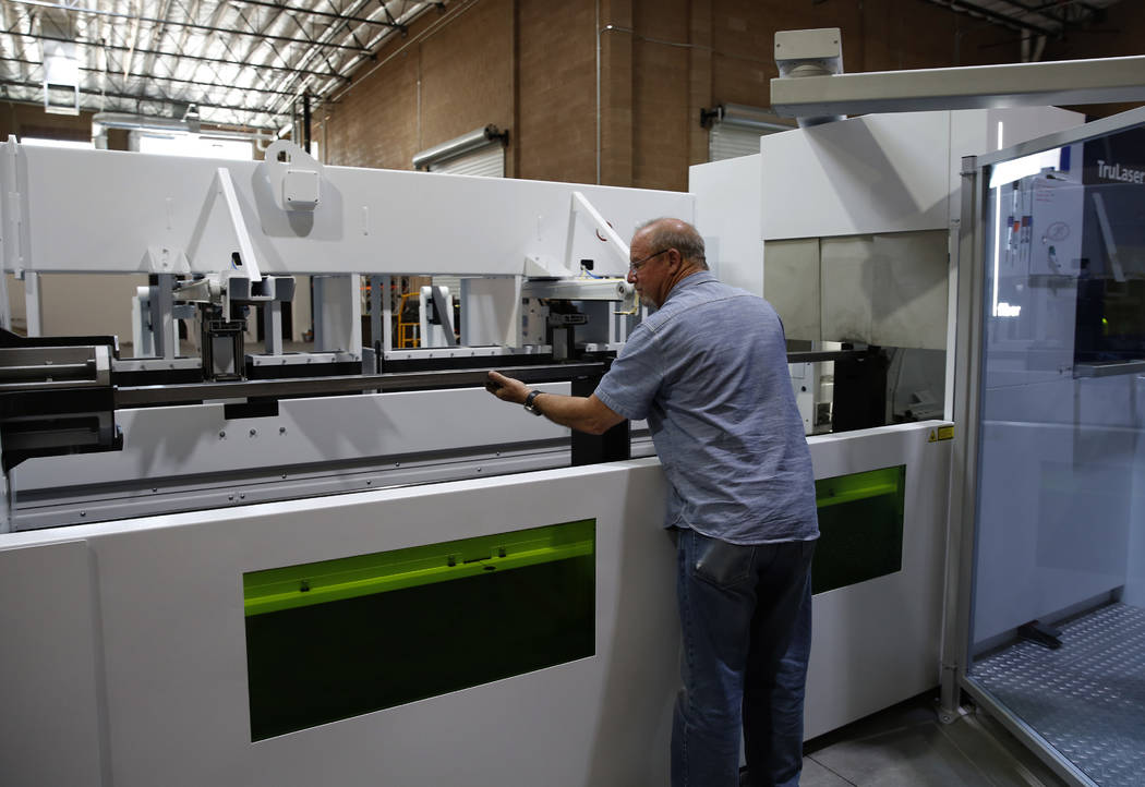 Barry Yost, co-owner of Precision Tube Laser, LLC, places a metal pipe into the TruLaser Tube 5000 laser cutting machine on Wednesday, June 20, 2018, in Las Vegas. Bizuayehu Tesfaye/Las Vegas Revi ...