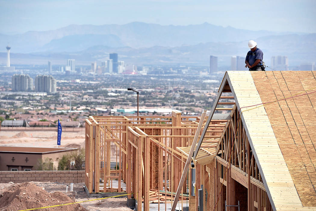 A carpenter works on the roof of a new home under construction at the western edge of Las Vegas in 2015. (Las Vegas Review-Journal)